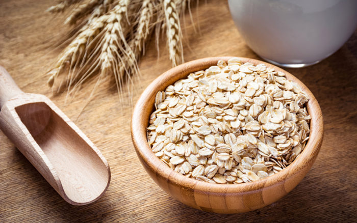 a bowl of oats on a wooden table