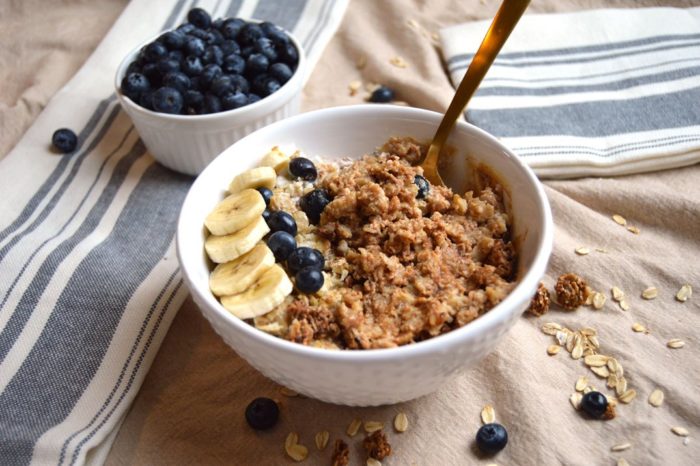 Bowl of porridge oats with banana and buleberry on top